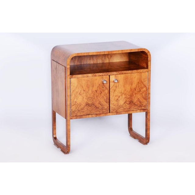 This elegant Art Deco cabinet comes from Czechoslovakia from the early 20th century. Made of blockboard veneered with...