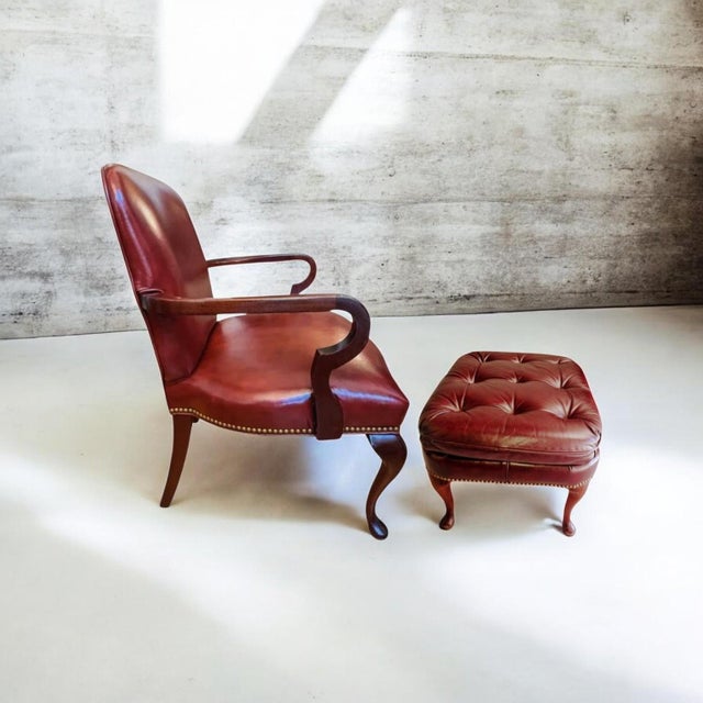 The Ultimate Statement of Traditional Elegance: The Leathercraft Open Armchair & Tufted Ottoman Set Experience the...