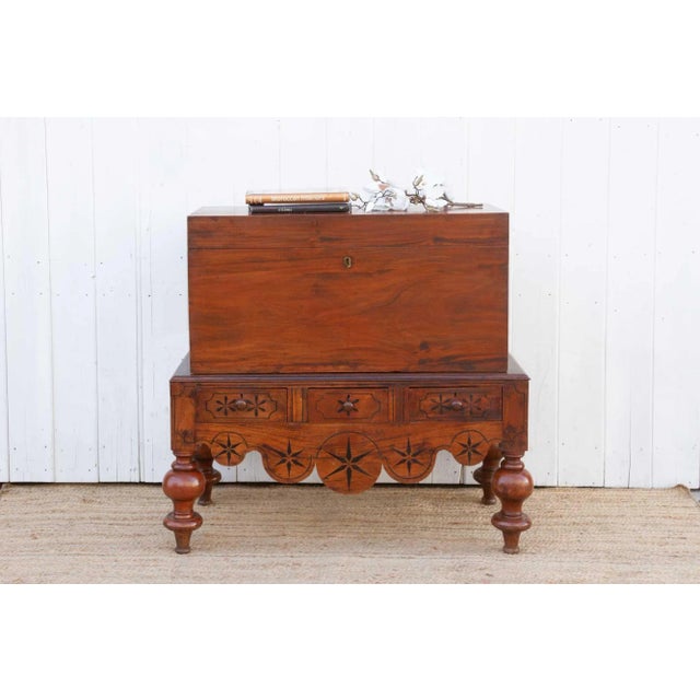 This fine antique Dutch colonial chest on stand displays an attractive wood grain with contrasting ebony star motif...