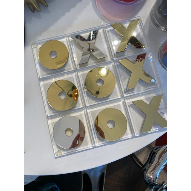 Four ways to play with this gold/silver acrylic game. The game set includes a clear acrylic board plus 5 Xs and 5 Os that...