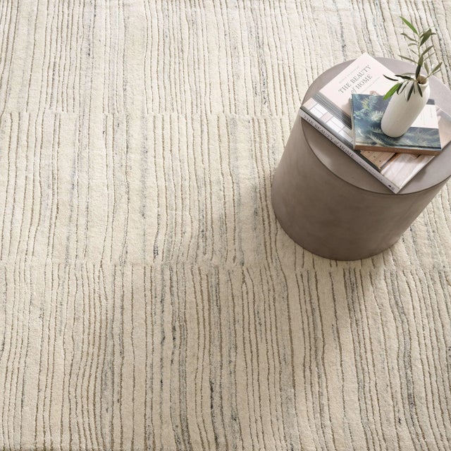 Inspired by substrate layers of sandstone sediments that chronicle the millennia, this luxurious, irregularly striped wool...
