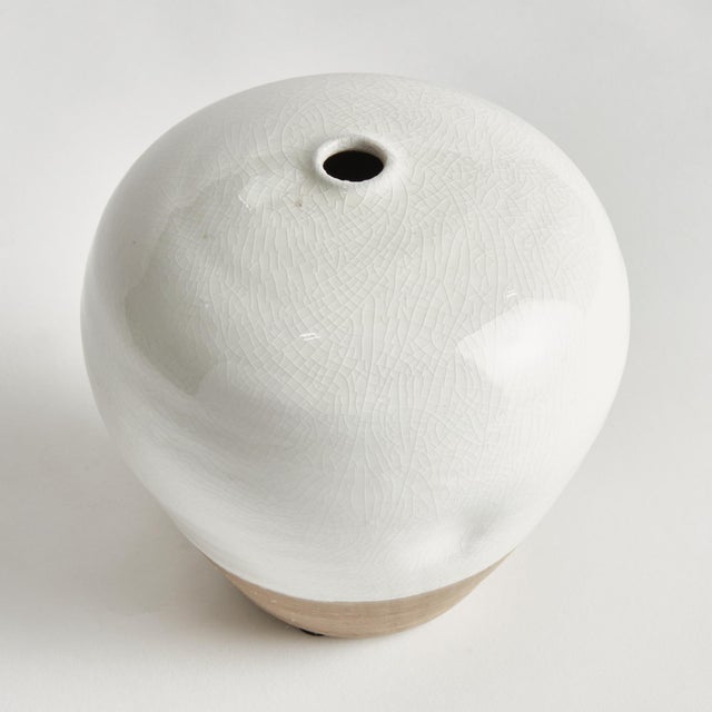 This terracotta vase is finished in a shinyWhite reactive glaze with a raw clay base, which is the natural touch that...