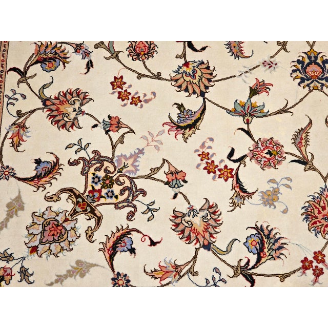 6’ 8” x 10’ Wonderfully graceful and beautiful fine weave Persian Tabriz room size rug in an allover floral pattern with...