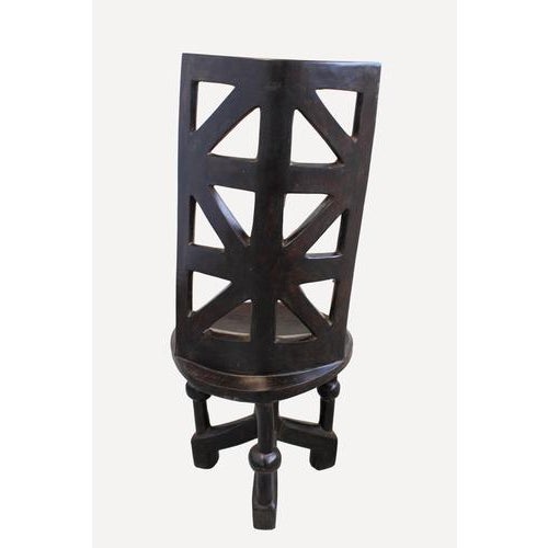 Hand carved wooden chair. The Makonde are an ethnic group in southeast Tanzania and northern Mozambique. Across Tanzania...