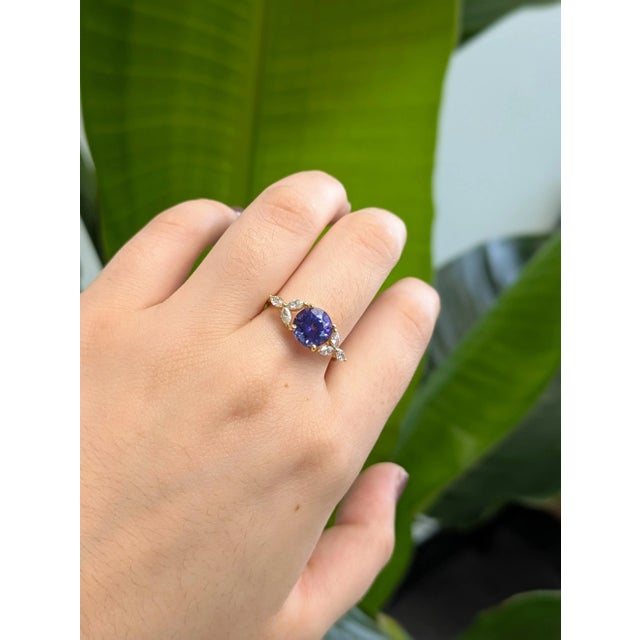 A ring that speaks volumes—this 1.99ct Tanzanite dazzles with a bold round cut and rich blue-violet hues. Nestled in 14k...