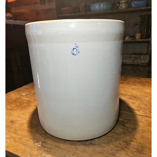 This 6-gallon salt-glazed stoneware was likely made by A.D. Ruckel in Whitehall, Illinois, sometime between 1900 and 1940....