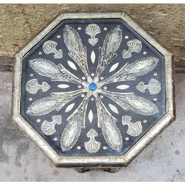 A new arrival. This beautiful metal inlaid Moroccan side table measures approximately 20" high and 17.5" from side to...