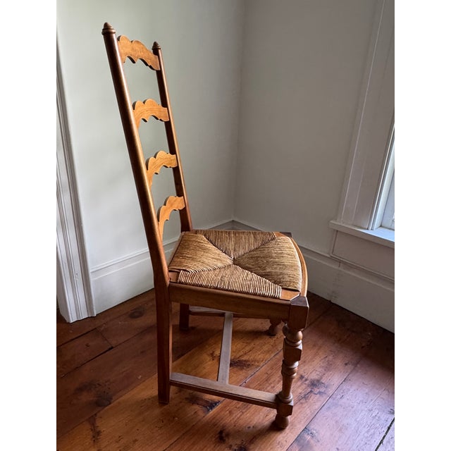 A lovely set of six French country style dining chairs in solid oak, each with tall, pitched ladder backs featuring four...