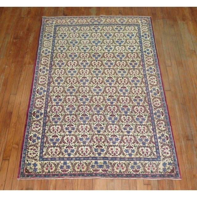 A 20th century Persian Kerman with a matching repetitive floral design in field and border.