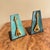 A pair of faux copper verdigris finished bookends. Enameled and brass lyre on a metal base. Signed Oppenheim and Israel....