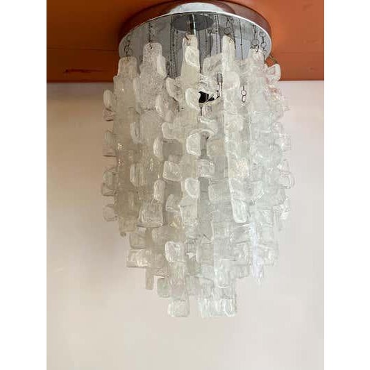 Italian fused flush mounted light fixture. Chrome round mounting ring. Each crystal hangs down with a small chain. Fixture...