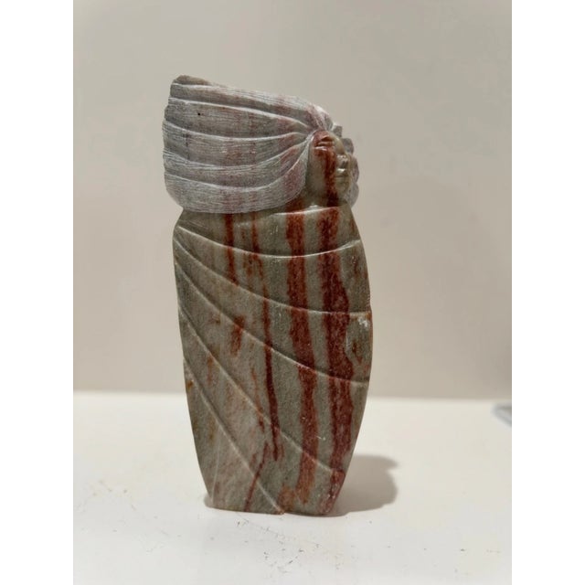 Striking vintage hand-carved stone sculpture signed NEDA, featuring a stylized human form with flowing hair rendered in...