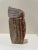 Striking vintage hand-carved stone sculpture signed NEDA, featuring a stylized human form with flowing hair rendered in...