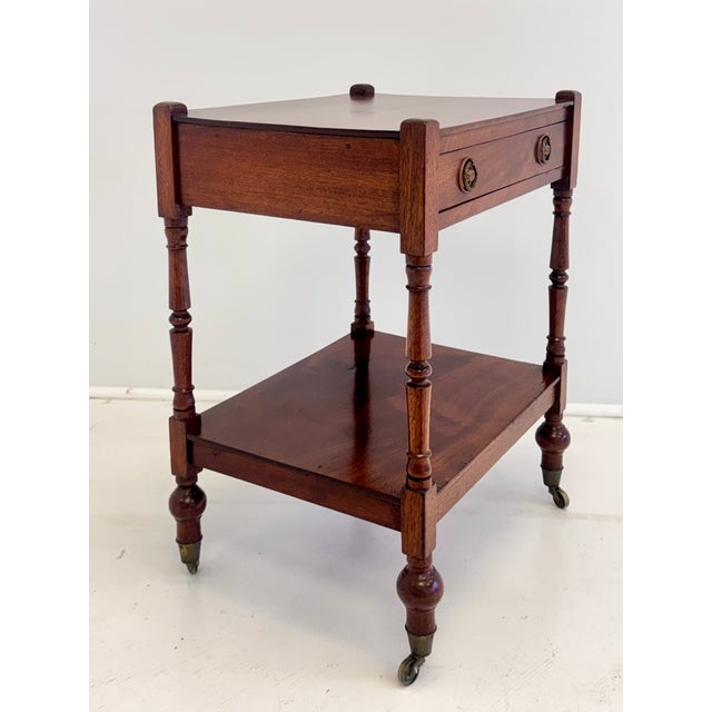 A handsome English mahogany side table dating to the early to mid-20th century, incorporating traditional Georgian details...