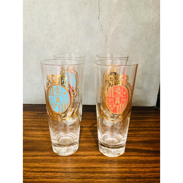 Pilsner style high ball glasses with a lions coat of arms. In very good condition no fading or scratches.