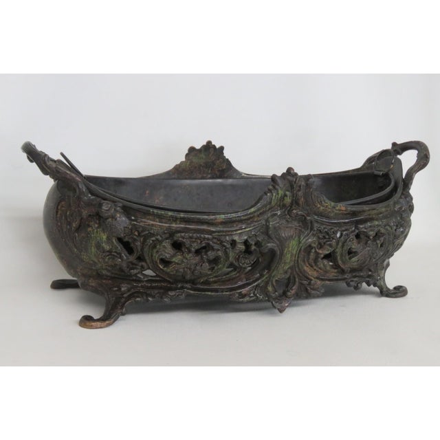 This gorgeous Jardinière / Planter is made of metal. The outer basin features a beautiful French Rococo design with an...