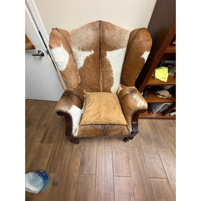 Beautiful genuine cowhide wingback chair in excellent condition. This is a solid, well-made piece with real hair-on...
