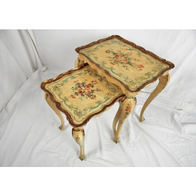 1950s hand-painted Florentine Nesting tables, pair. Each tables is crafted of a light wood and hand-painted in a classic...