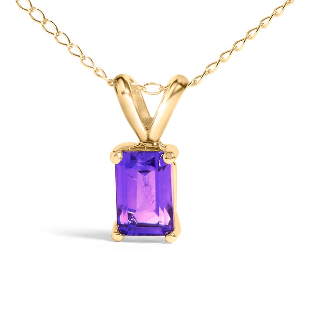 Draped in the regal splendor of a color-enhanced, natural amethyst, this 14K yellow gold pendant necklace exudes elegance...
