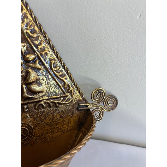 Ornate Hosley metal wall pocket featuring embossed floral motifs, rope-style edging, curled side accents, and a circular...