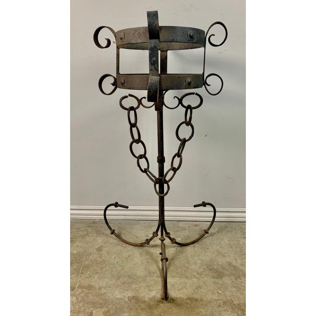 Pair of Spanish hand wrought iron planters standing on tripod bases and decorated with garlands of chain.
