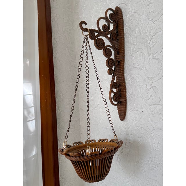1960s plant hanger and wall bracket. Made of synthetic resin, this durable plant hanger has the look of a rattan basket...