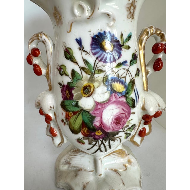 Two antique vases each with a slightly different floral design.Early 1900’s or late 1800’s. In excellent shape no chips...