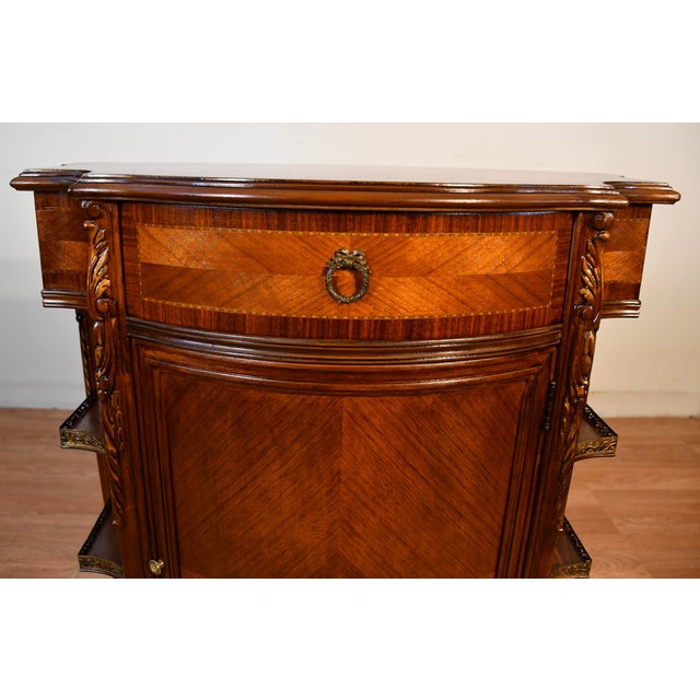 We are pleased to offer this beautiful Antique French Louis XV cabinet, from the 1920s. This stand is made of Walnut &...