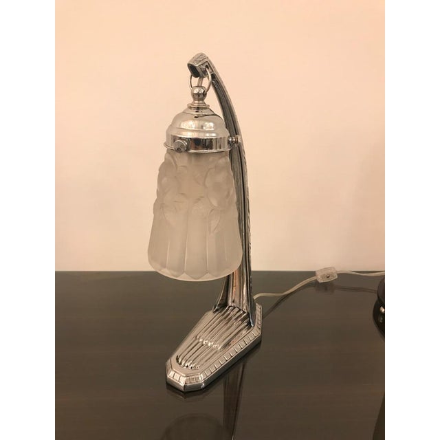 Gorgeous French Art Deco desk / table lamp by Degue. Having floral shade in frosted glass with polished details. Held by a...