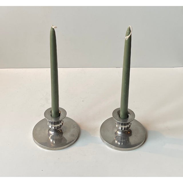 A pair of candleholders designed and made by just andensen in denmark during the 1930s or 40s. They are made from the...