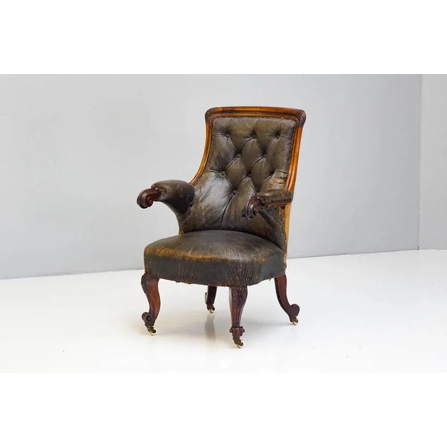 Fantastic rosewood framed armchair in original leather with deep buttoned and exposed back. Fabulous quality and design.