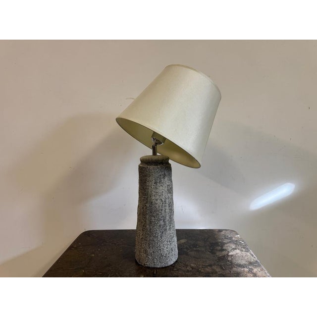 Ceramic table lamp A striking ceramic table lamp with a sculptural, textured base that exudes a raw, organic charm. The...