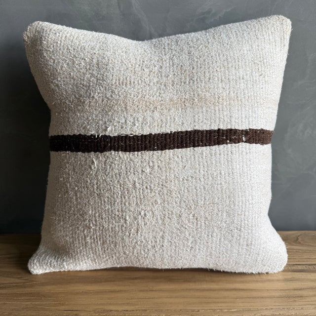 Creamy white hemp rug pillow with stripes. Soft hand, linen blend backing with zipper closure. Spot cleaning is...