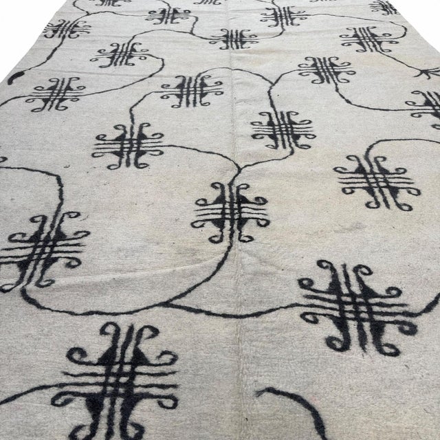 This striking modern felt rug from Central Asia blends traditional tribal inspiration with a contemporary sensibility. The...