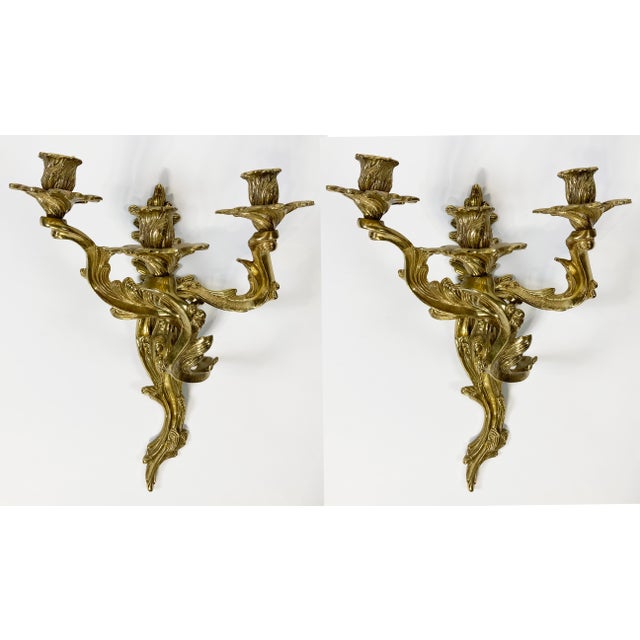 Elegant pair of 20th C Louis XV style cast brass sconces made by Glo-Mar Artworks Inc of New York City. Heavy pieces that...