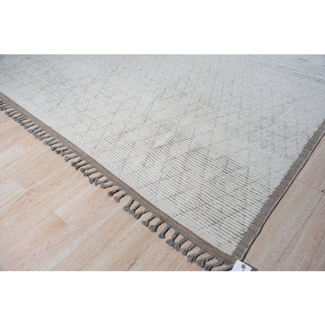 Hand-knotted in wool, this 10 x 14 Marrakech Berber rug carpet is a refined foundation for contemporary and tribal-...