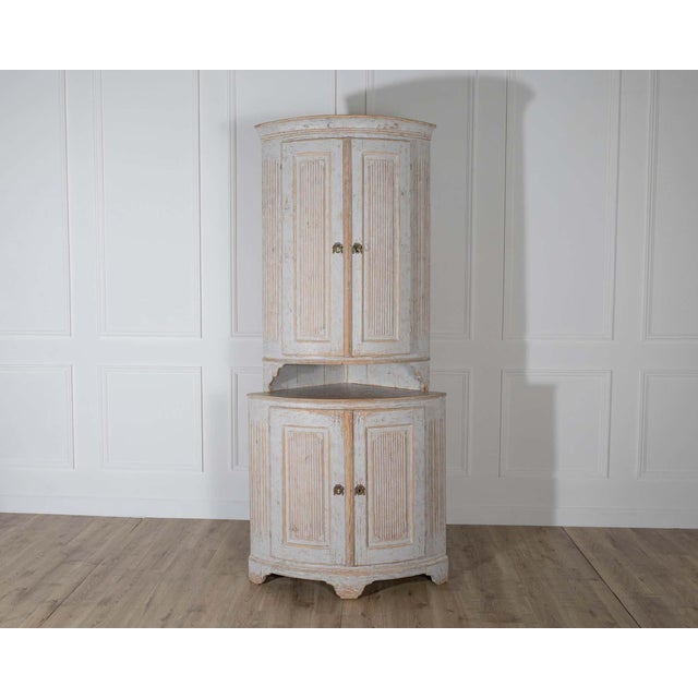 A striking late 18th-century Gustavian period corner cabinet from Sweden, featuring the classic neoclassical elegance of...