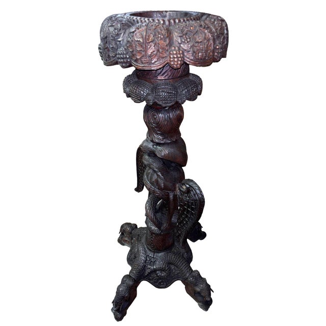 A highly decorative colonial, finely carved and pierced wooden flower stand with prolific foliage and wildlife design. A...