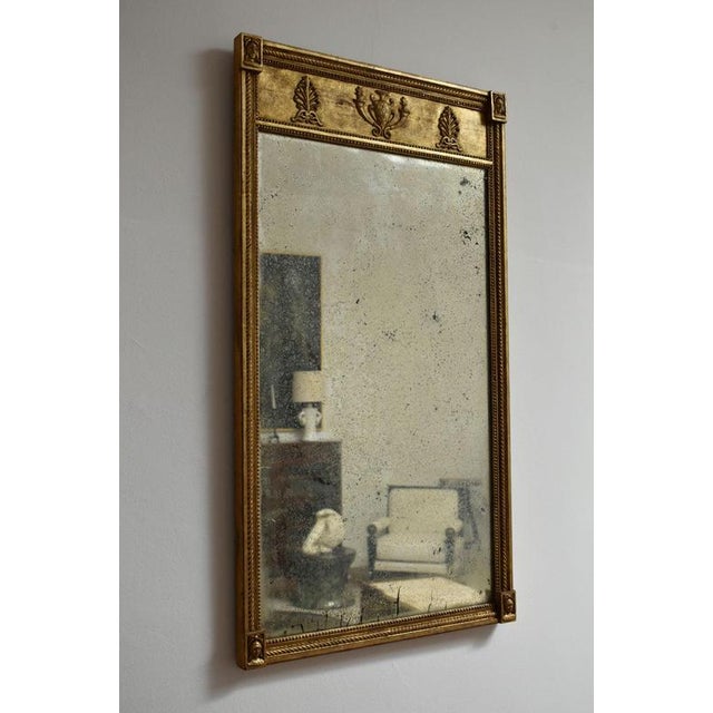 Gilded neoclassical style mirror, XIXth c. Neoclassical style mirror with carved and gilded wooden frameRectangular shape,...