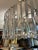Gorgeous oval Italian crystal prism chandelier with white acrylic diffuser. It comes with its adjustable chrome finish...