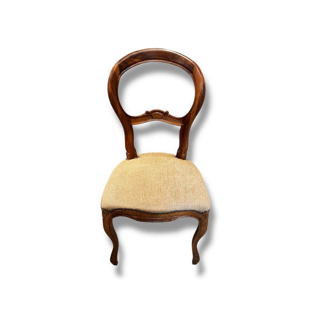 A beautiful set of six antique walnut dining chairs, approximately 100 years old, showcasing elegant craftsmanship and...