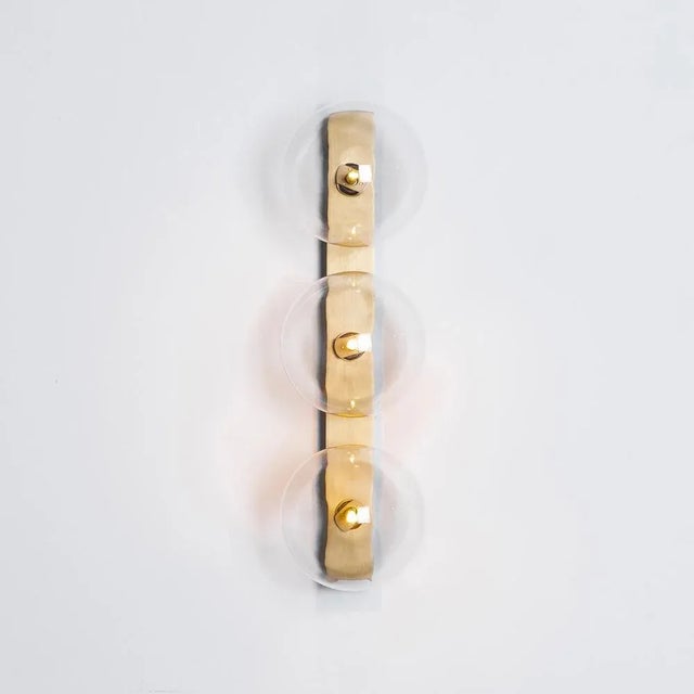 Oslo triple brass wall sconce by schwung dimensions: w 15 x d 19 x h 50 cm materials: solid brass, hand blown glass globes...