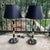 Elegant brass and black lamps, in the manner of Tommi Parzinger, American, circa 1950s. They have been rewired and are...