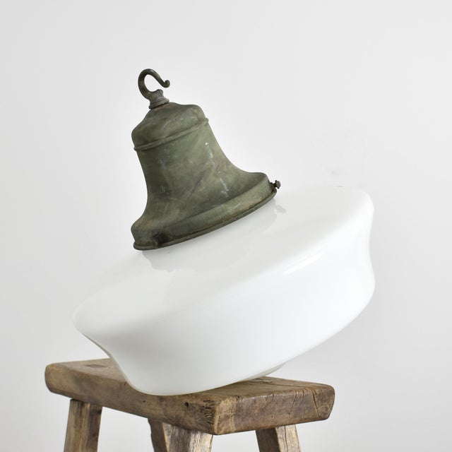 An original opaline glass pendant light. The light has a large milk glass opaline shade in a lovely shape and has retained...
