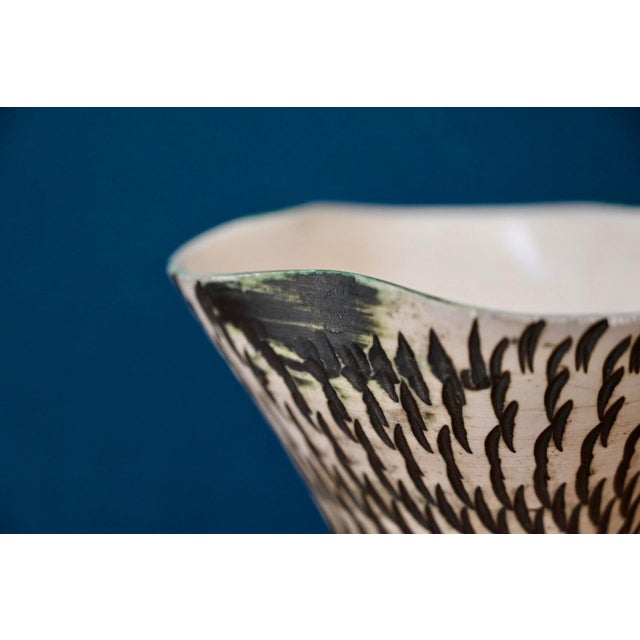 Textured, even striated, and beautifully graphic, this antique vase is a lovely decorative piece. Slightly corolla-shaped,...