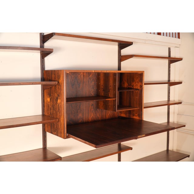 Designed by Kai Kristiansen for FM Møbler, this Danish Modern wall unit is crafted from richly grained rosewood solids and...