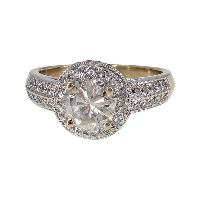 Estate Natural Diamond Halo Engagement Ring. This estate engagement ring is crafted in 18 karat white gold featuring a .86...