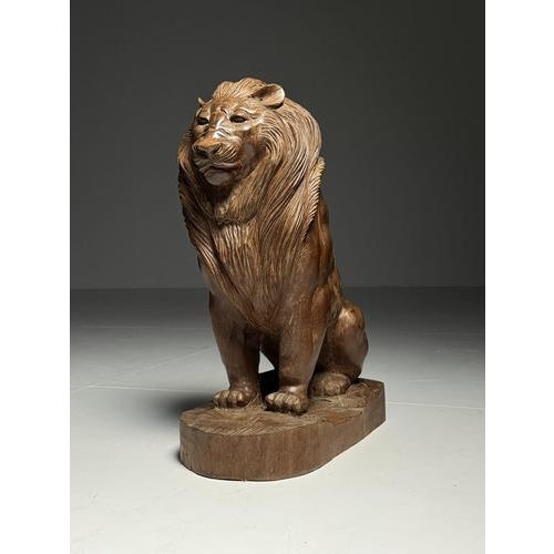 Large (probably) teak wood carving/sculpture of a lion in a seated position. Originating from Southeast Asia, late 20th...