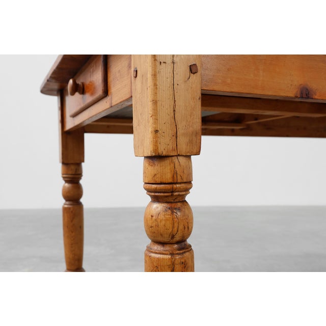 A charming French farmhouse table in solid pine, dating from the late 19th century. This piece embodies rustic...