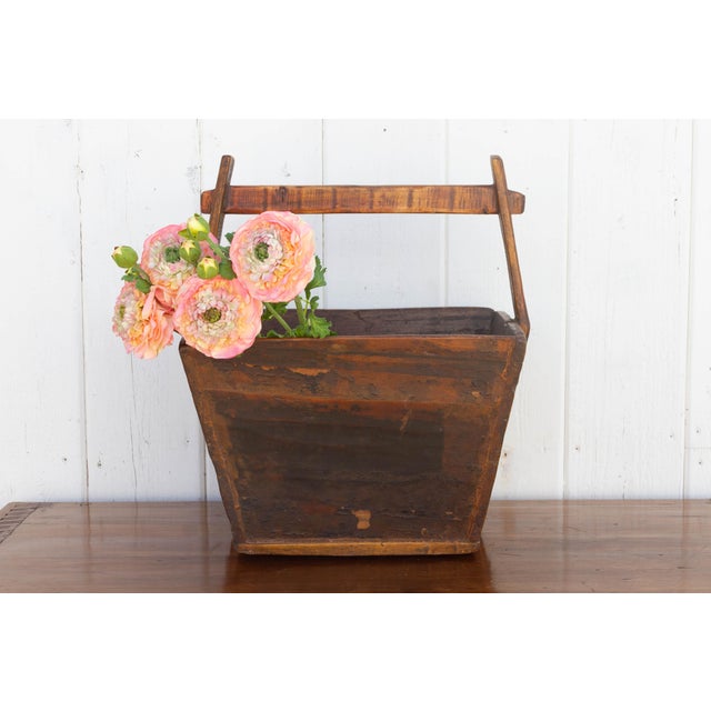Antique Chinese wooden basket! Its weathered wood, kissed with a warm aged patina, whispers tales of countless harvests,...